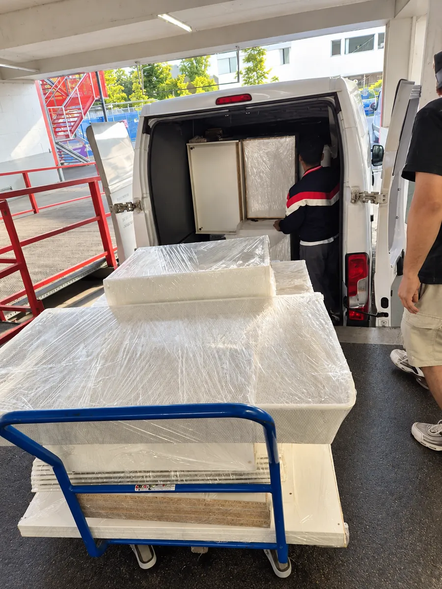 Loading wrapped furniture parts into the moving van